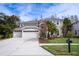 Two-story house with a three-car garage and landscaped yard at 18809 Chaville Rd, Lutz, FL 33558