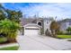 Two-story house with a three-car garage and manicured lawn at 18809 Chaville Rd, Lutz, FL 33558