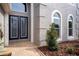 Elegant double-door entry with glass inserts and a stone walkway at 18809 Chaville Rd, Lutz, FL 33558