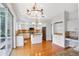 Bright kitchen with white cabinets, granite countertops, and island at 18809 Chaville Rd, Lutz, FL 33558