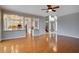 Open concept living room with hardwood floors and views into the kitchen at 18809 Chaville Rd, Lutz, FL 33558