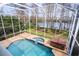 Inviting pool and spa area with a screened enclosure at 18809 Chaville Rd, Lutz, FL 33558