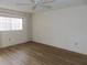 Spacious bedroom featuring wood-look floors and large window at 19029 Us Highway 19 N # 23C, Clearwater, FL 33764