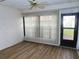 Bright living room with wood-look floors and sliding glass door at 19029 Us Highway 19 N # 23C, Clearwater, FL 33764