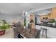 Open concept dining area with marble table and kitchen view at 20 Sylvia Pl, Oldsmar, FL 34677