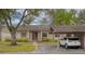 Exterior view of a condo with a carport and American flag at 20 Sylvia Pl, Oldsmar, FL 34677