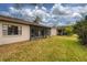 Tan house exterior with grassy yard and screened porch at 20 Sylvia Pl, Oldsmar, FL 34677