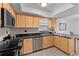 Well-equipped kitchen featuring black countertops and modern appliances at 20 Sylvia Pl, Oldsmar, FL 34677