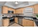 Modern kitchen featuring stainless steel appliances and granite countertops at 20 Sylvia Pl, Oldsmar, FL 34677