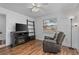 Living room with fireplace, wood floors, and comfy recliner at 20 Sylvia Pl, Oldsmar, FL 34677