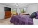 Spacious main bedroom with plush purple bedding and large windows at 20 Sylvia Pl, Oldsmar, FL 34677