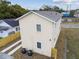 Aerial view of a newly built light beige house with a gray roof and two AC units at 2204 E 12Th Ave, Tampa, FL 33605