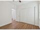 Bedroom with wood floors, double door closet and access to another room at 2204 E 12Th Ave, Tampa, FL 33605