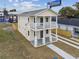 Two-story house with light yellow siding, a balcony, and a driveway at 2204 E 12Th Ave, Tampa, FL 33605