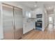 Modern kitchen with white shaker cabinets, stainless steel appliances, and vinyl flooring at 2204 E 12Th Ave, Tampa, FL 33605