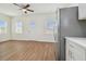 Living room with wood floors, ceiling fan and kitchen access at 2204 E 12Th Ave, Tampa, FL 33605