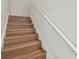 Clean staircase with wood steps and white railing at 2204 E 12Th Ave, Tampa, FL 33605