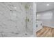 Elegant bathroom featuring a marble shower and modern fixtures at 2215 Cedar Dr, Dunedin, FL 34698