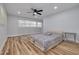 Spacious bedroom with ceiling fan and wood-look flooring at 2215 Cedar Dr, Dunedin, FL 34698