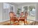 Charming dining area with glass table and sliding doors to patio at 2215 Cedar Dr, Dunedin, FL 34698