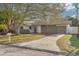 Updated single story home with gray stone facade and landscaped yard at 2215 Cedar Dr, Dunedin, FL 34698