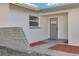 Newly renovated front entrance with modern gray door and stone accents at 2215 Cedar Dr, Dunedin, FL 34698