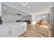 Modern white kitchen with stainless steel appliances and breakfast bar at 2215 Cedar Dr, Dunedin, FL 34698