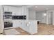 Updated kitchen featuring a breakfast bar and wood-look flooring at 2215 Cedar Dr, Dunedin, FL 34698