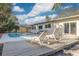 Enjoy this refreshing pool with a deck and lounge chairs at 2215 Cedar Dr, Dunedin, FL 34698