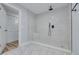 Large walk-in shower with marble tile and a rain shower head at 2215 Cedar Dr, Dunedin, FL 34698