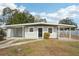 Newly renovated home with gray exterior, black door, and landscaped yard at 2503 W Crawford St, Tampa, FL 33614