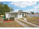 Newly renovated home with gray exterior, black door, and landscaped yard at 2503 W Crawford St, Tampa, FL 33614