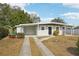 Newly renovated home with gray exterior, black door, and landscaped yard at 2503 W Crawford St, Tampa, FL 33614