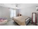 Spacious bedroom with a queen bed, toddler bed, and ceiling fan at 2606 S Wilder Loop, Plant City, FL 33565