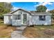 Single story home with green door, walkway, and landscaping at 2606 S Wilder Loop, Plant City, FL 33565