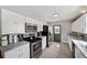 Modern kitchen with white cabinets, stainless steel appliances and a back door at 2606 S Wilder Loop, Plant City, FL 33565