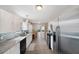 Modern kitchen with white cabinets, stainless steel appliances and a view to dining area at 2606 S Wilder Loop, Plant City, FL 33565