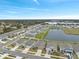 Aerial view of houses near a lake and farmlands at 2812 Gumbo Limbo Dr, Wimauma, FL 33598