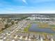 Aerial view of houses near a lake and farmlands at 2812 Gumbo Limbo Dr, Wimauma, FL 33598