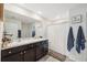 Double vanity bathroom with dark brown cabinets and a shower/tub combo at 2812 Gumbo Limbo Dr, Wimauma, FL 33598