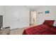 Red bedroom with a wood-look floor and access to a bathroom at 2812 Gumbo Limbo Dr, Wimauma, FL 33598