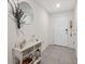 Bright entryway with tile flooring, console table, and mirror at 2812 Gumbo Limbo Dr, Wimauma, FL 33598