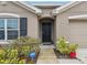 Front door entrance with landscaping at 2812 Gumbo Limbo Dr, Wimauma, FL 33598