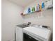 Laundry room with washer, dryer, and shelving for storage at 2812 Gumbo Limbo Dr, Wimauma, FL 33598