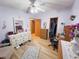 Bright bedroom with wood flooring, dresser, and desk at 3020 Moss Hill St, Wesley Chapel, FL 33543