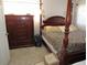 Bedroom with a four poster bed, dresser and carpeted floors at 3060 64Th N Ave, St Petersburg, FL 33702