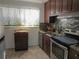 Functional kitchen featuring stainless steel appliances, and butterfly themed curtain at 3060 64Th N Ave, St Petersburg, FL 33702