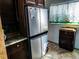 Spacious kitchen featuring stainless steel refrigerator and butterfly themed curtain at 3060 64Th N Ave, St Petersburg, FL 33702