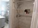 Modern shower with tiled walls, shower head and shelves for storage at 3060 64Th N Ave, St Petersburg, FL 33702