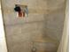 Modern shower featuring a tiled bench, a built-in niche, and decorative stone accents at 3060 64Th N Ave, St Petersburg, FL 33702